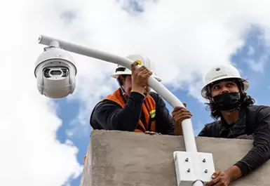 Ingenieros realizando mantenimiento preventivo y limpieza física a una cámara de seguridad CCTV